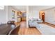 Bright living room showcasing hardwood floors seamlessly connecting to the kitchen at 4850 E Dartmouth Ave, Denver, CO 80222