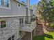 Back of home shows a deck, patio, and fenced yard with mature trees at 126 Mc Intyre Circle, Golden, CO 80401