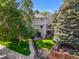 This home includes a green backyard with a patio and mature trees at 126 Mc Intyre Circle, Golden, CO 80401