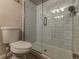 Bathroom featuring a toilet and a glass shower with white subway tile and brushed nickel hardware at 126 Mc Intyre Circle, Golden, CO 80401