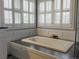 Elegant bathroom featuring a relaxing soaking tub with natural light streaming through plantation shutters at 126 Mc Intyre Circle, Golden, CO 80401