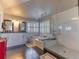 Bathroom showcasing double vanity, soaking tub, and frameless glass shower at 126 Mc Intyre Circle, Golden, CO 80401