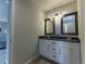Well-lit bathroom with double vanity, framed mirrors, and modern fixtures at 126 Mc Intyre Circle, Golden, CO 80401
