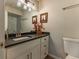 Well-lit bathroom vanity with a modern mirror, white cabinets, and granite countertops at 126 Mc Intyre Circle, Golden, CO 80401