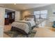 Bedroom with a large bed, neutral colors, and a doorway leading to the wet bar at 126 Mc Intyre Circle, Golden, CO 80401