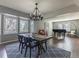 Bright and airy dining room features an elegant chandelier, and view from large windows at 126 Mc Intyre Circle, Golden, CO 80401