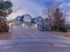 Charming two-story home with a three-car garage and well-maintained landscaping, taken at dusk at 126 Mc Intyre Circle, Golden, CO 80401