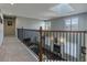 Open hallway with carpet, wood railing and a view of the fireplace and backyard at 126 Mc Intyre Circle, Golden, CO 80401