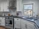 Modern kitchen featuring stainless steel appliances, white cabinets, and dark countertops at 126 Mc Intyre Circle, Golden, CO 80401