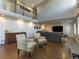 Open living room with hardwood floors, accent wall and view of the second story landing at 126 Mc Intyre Circle, Golden, CO 80401