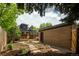 Exterior view of a charming home with a brick garage and landscaping at 1169 Cook St, Denver, CO 80206