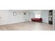 Finished basement with light wood flooring, bright walls, a red sofa and exterior access at 1169 Cook St, Denver, CO 80206