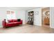 Finished basement with light wood flooring, bright walls, a red sofa and exterior access at 1169 Cook St, Denver, CO 80206