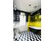 Stylish bathroom featuring a black clawfoot tub, checkered tile floor, and bright yellow shower curtain at 1169 Cook St, Denver, CO 80206