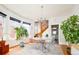 Sunlit dining area with contemporary chandelier and stairway at 1169 Cook St, Denver, CO 80206