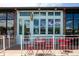 Exterior view of ice cream shop showing the facade, outdoor seating area with red chairs and tables at 1169 Cook St, Denver, CO 80206
