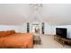 Bright and airy main bedroom featuring vaulted ceilings, dormer windows and a separate sitting area with TV at 1169 Cook St, Denver, CO 80206