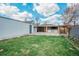 Backyard with covered patio, grass yard and exterior metal garage at 948 S Tennyson St, Denver, CO 80219