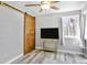 Charming bedroom with wooden barn door, neutral walls and trim at 948 S Tennyson St, Denver, CO 80219
