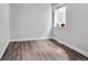 Empty bedroom with light gray walls, neutral trim and wood floors at 948 S Tennyson St, Denver, CO 80219