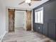 Bedroom featuring gray ship lap walls, with wooden barn doors and an interior closet system at 948 S Tennyson St, Denver, CO 80219