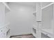 White walk-in closet with custom built-in shelving and drawers for maximum organization at 948 S Tennyson St, Denver, CO 80219