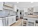 Modern kitchen with stainless steel appliances, tile backsplash, and center island for cooking at 948 S Tennyson St, Denver, CO 80219