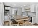 Spacious kitchen featuring stainless steel appliances, a tile backsplash, and a large center island at 948 S Tennyson St, Denver, CO 80219