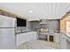 Fully-equipped outdoor kitchen with a built-in grill, sink, and stainless steel refrigerator at 948 S Tennyson St, Denver, CO 80219