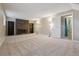 Finished basement featuring a brick fireplace, built-in bookshelves, and a doorway to the bathroom at 2123 S Joplin Way, Aurora, CO 80013