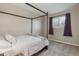 Cozy bedroom with a metal-framed bed and window with purple curtains at 2123 S Joplin Way, Aurora, CO 80013