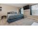 Primary bedroom with a plush bed, neutral walls, and natural light from the window at 2123 S Joplin Way, Aurora, CO 80013