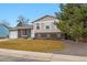 Charming bi-level home showcasing brick facade and well-manicured lawn at 2123 S Joplin Way, Aurora, CO 80013
