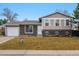 Charming bi-level home with a well-manicured lawn and a classic brick and siding facade at 2123 S Joplin Way, Aurora, CO 80013