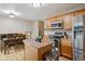 Open concept kitchen with island, stainless appliances, seamlessly flowing into dining area at 2123 S Joplin Way, Aurora, CO 80013