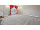 Bright living room featuring neutral carpet, large window, and elegant curtains at 2123 S Joplin Way, Aurora, CO 80013