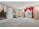 Bright living room featuring neutral carpet, staircase and elegant curtains at 2123 S Joplin Way, Aurora, CO 80013