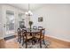 Cozy dining room with hardwood floors and a round table with seating for six at 1962 Canyonpoint Ln, Castle Pines, CO 80108