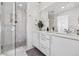 Luxurious bathroom featuring glass enclosed shower, double vanity with modern fixtures, and stylish mirror at 3036 Wilson Ct # 5, Denver, CO 80205
