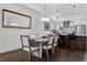 Light-filled dining room featuring a modern chandelier, large mirror and wood floors at 3036 Wilson Ct # 5, Denver, CO 80205