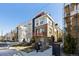 Modern townhouse exterior featuring mixed brick and siding with an orange balcony at 3036 Wilson Ct # 5, Denver, CO 80205
