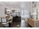 Stylish kitchen and dining area with modern lighting, stainless steel appliances, and breakfast bar at 3036 Wilson Ct # 5, Denver, CO 80205