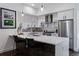 Modern kitchen with stainless steel appliances, white cabinets, and a large island with bar seating at 3036 Wilson Ct # 5, Denver, CO 80205