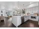 Modern kitchen with stainless steel appliances, a center island, and open floor plan to the living area at 3036 Wilson Ct # 5, Denver, CO 80205