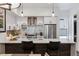 Bright kitchen with white cabinets, stainless appliances, stylish backsplash, and large island with seating at 3036 Wilson Ct # 5, Denver, CO 80205