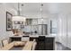 Modern kitchen features stainless steel appliances, range hood and an eat in kitchen island at 3036 Wilson Ct # 5, Denver, CO 80205