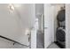 Convenient laundry area near the stairs featuring stackable washer and dryer units, maximizing space at 3036 Wilson Ct # 5, Denver, CO 80205