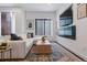 Cozy living room with comfortable sofa, stylish rug, and entertainment center with a built in fireplace at 3036 Wilson Ct # 5, Denver, CO 80205