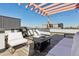 Inviting rooftop deck featuring stylish seating, a grill, and a pergola, ideal for entertaining at 3036 Wilson Ct # 5, Denver, CO 80205