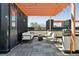 This rooftop patio features an orange pergola, patio furniture, and a grill for entertaining at 3036 Wilson Ct # 5, Denver, CO 80205